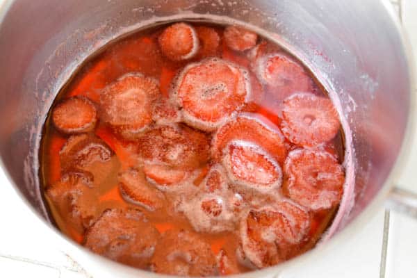 Sliced strawberries in a sauce pan to make a simple syrup.