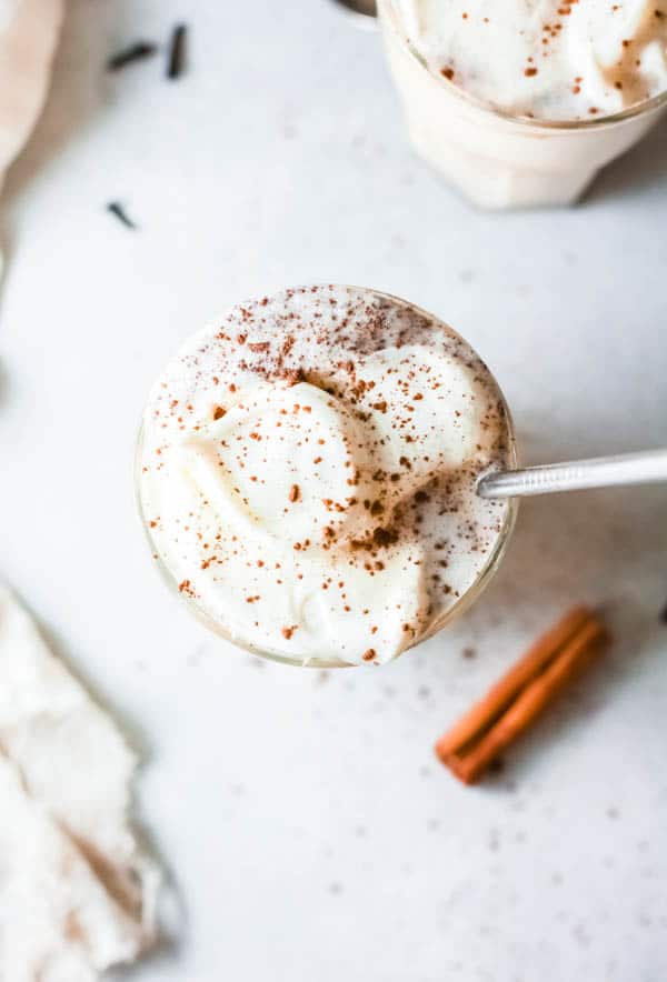 Top view of a pumpkin pie shake with sprinkled cinnamon on top of whipped cream.