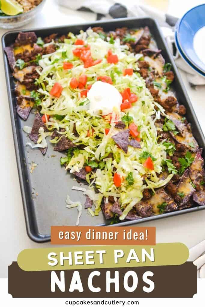 Text - Easy Dinner Idea Sheet Pan Nachos, with a tray of nachos on blue corn tortilla chips with toppings.
