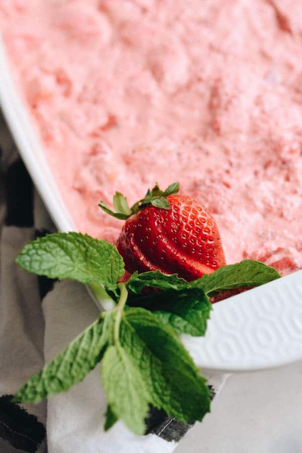 Close up on strawberry and mint garnish for a Strawberry Angel Food Cake dessert with JELLO.