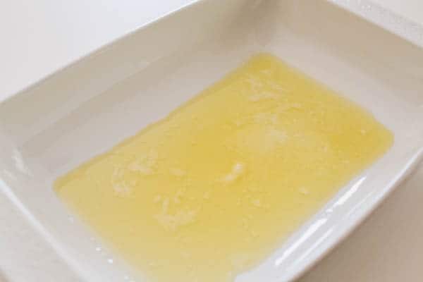 Melted butter in a baking dish.