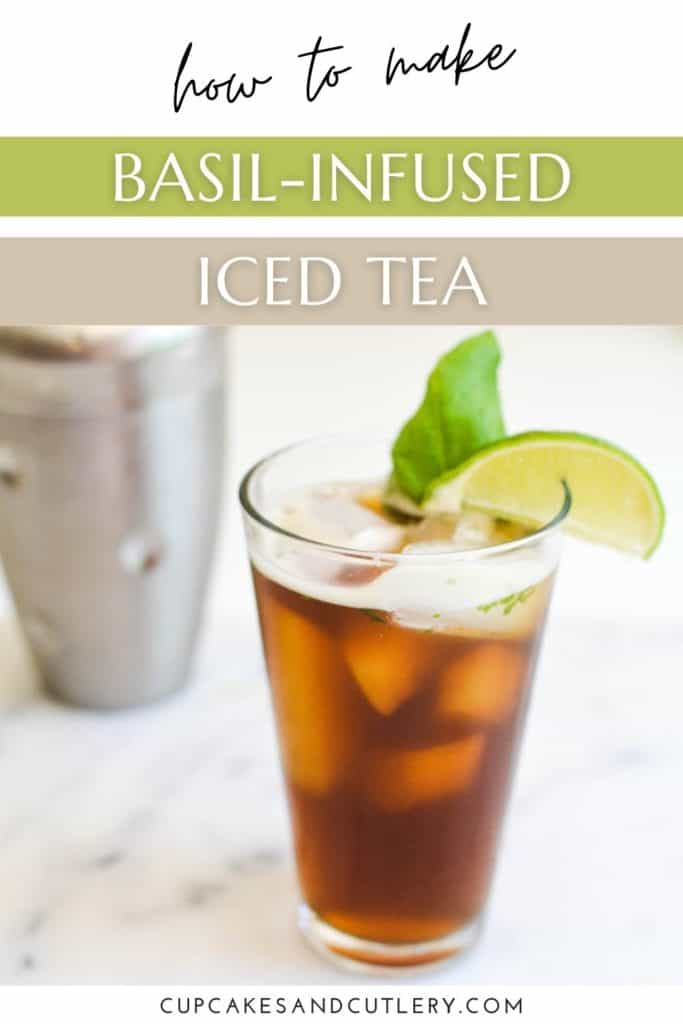A glass of iced tea on a table with a cocktail shaker in the background.