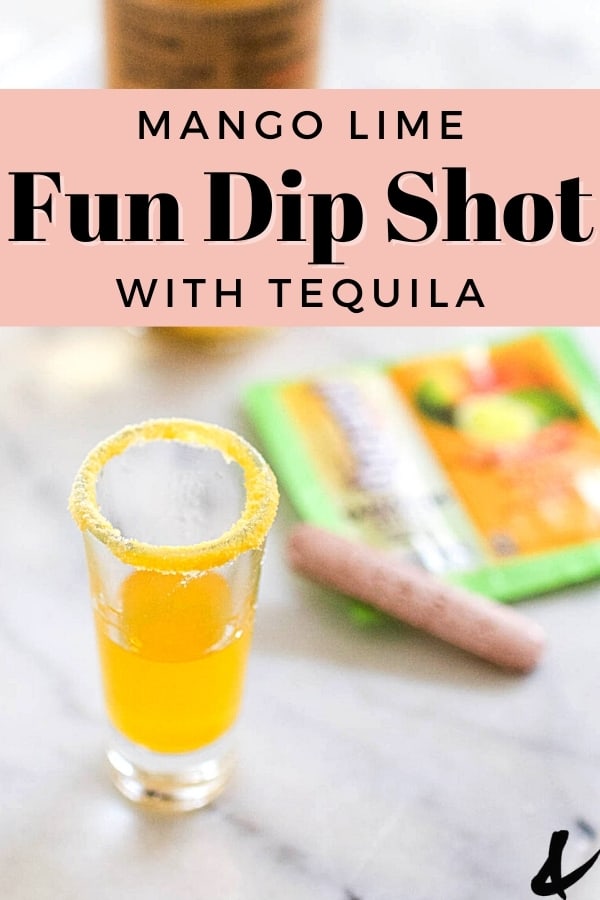 Fun dip shot made with mango lime fun dip on a table next to a package of candy.