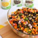 Close up of a bowl of Black Bean Salad with red bell pepper and red onions.