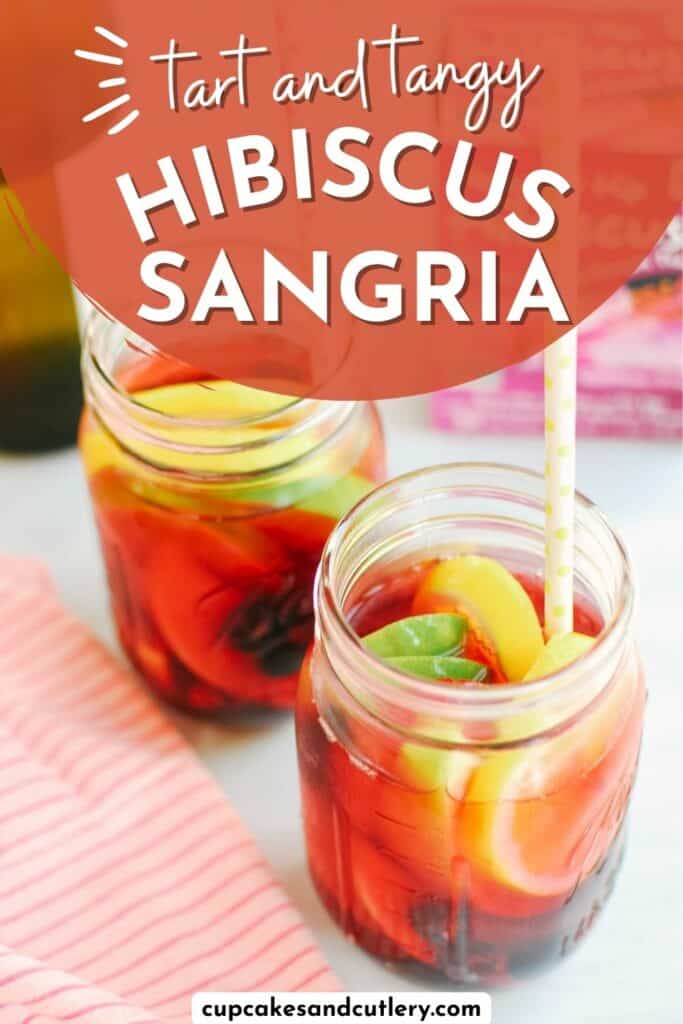 Text - Tart and tangy hibiscus sangria with two jars holding sliced fruit and a reddish colored drink.