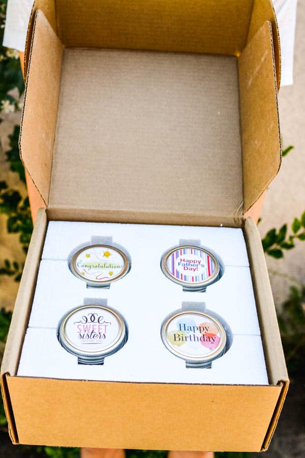 An open shipping box for cupcakes in a jar.