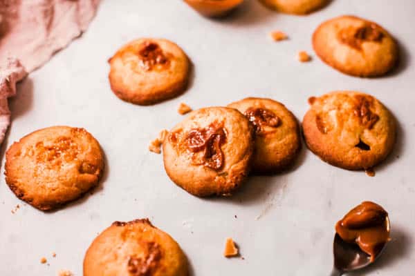 Walnut Butterscotch cookies scattered on a table.