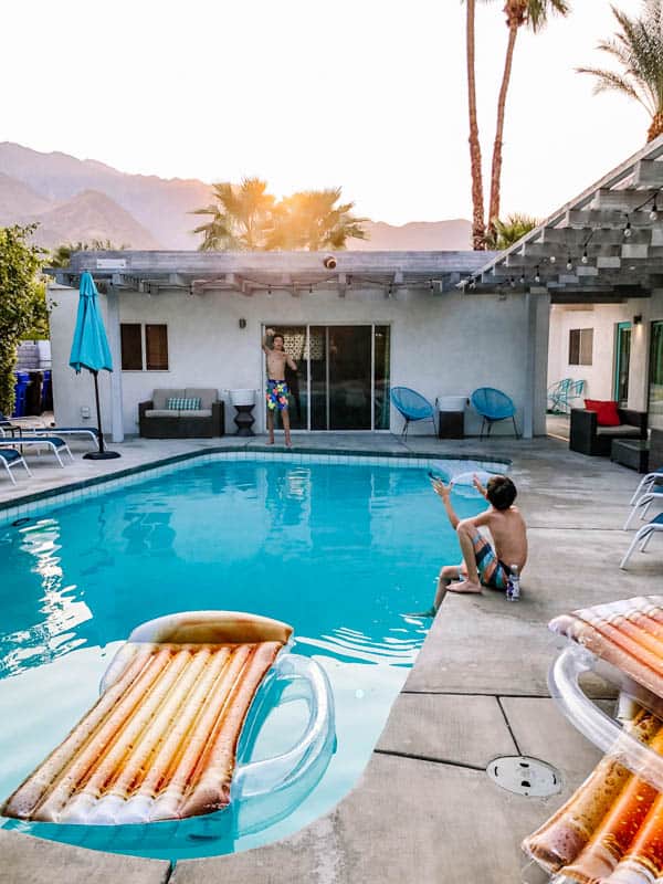 Kids playing ball around the pool in a Palm Springs backyard. 
