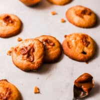 Square image of several Butterscotch Walnut Cookies o a table.