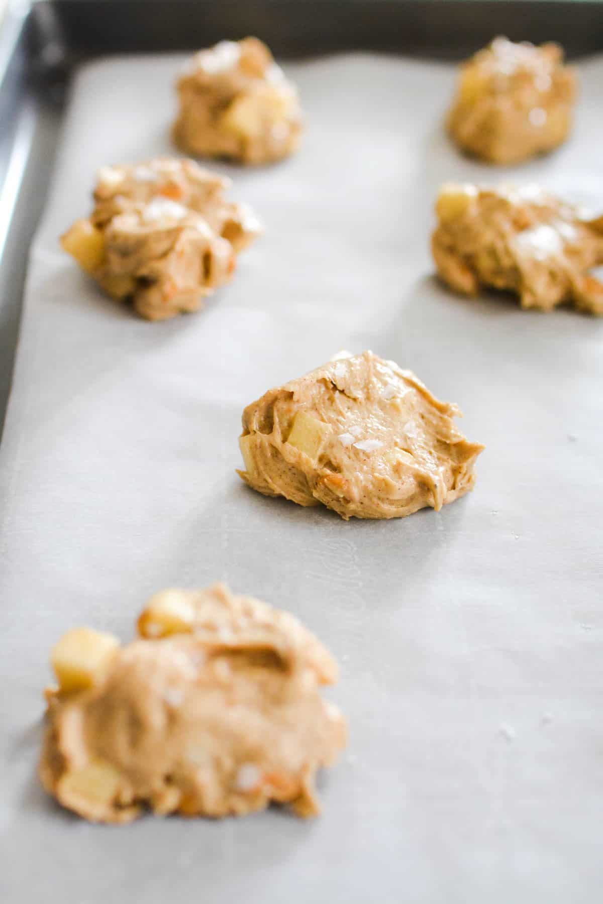Apple Butterscotch cookie batter dropped on a cookie sheet waiting to be baked.