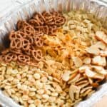 Close up of a homemade Chex snack mix in a disposable pan.