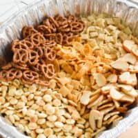 Close up of a homemade Chex snack mix in a disposable pan.