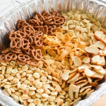 Close up of a homemade Chex snack mix in a disposable pan.