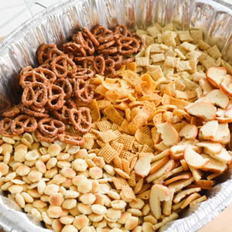 Close up of a homemade Chex snack mix in a disposable pan.
