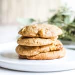 Close up of a plate with 4 cookies stacked on top of each other.