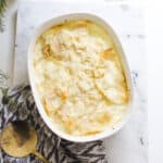 Baking dish with cooked casserole on a table.