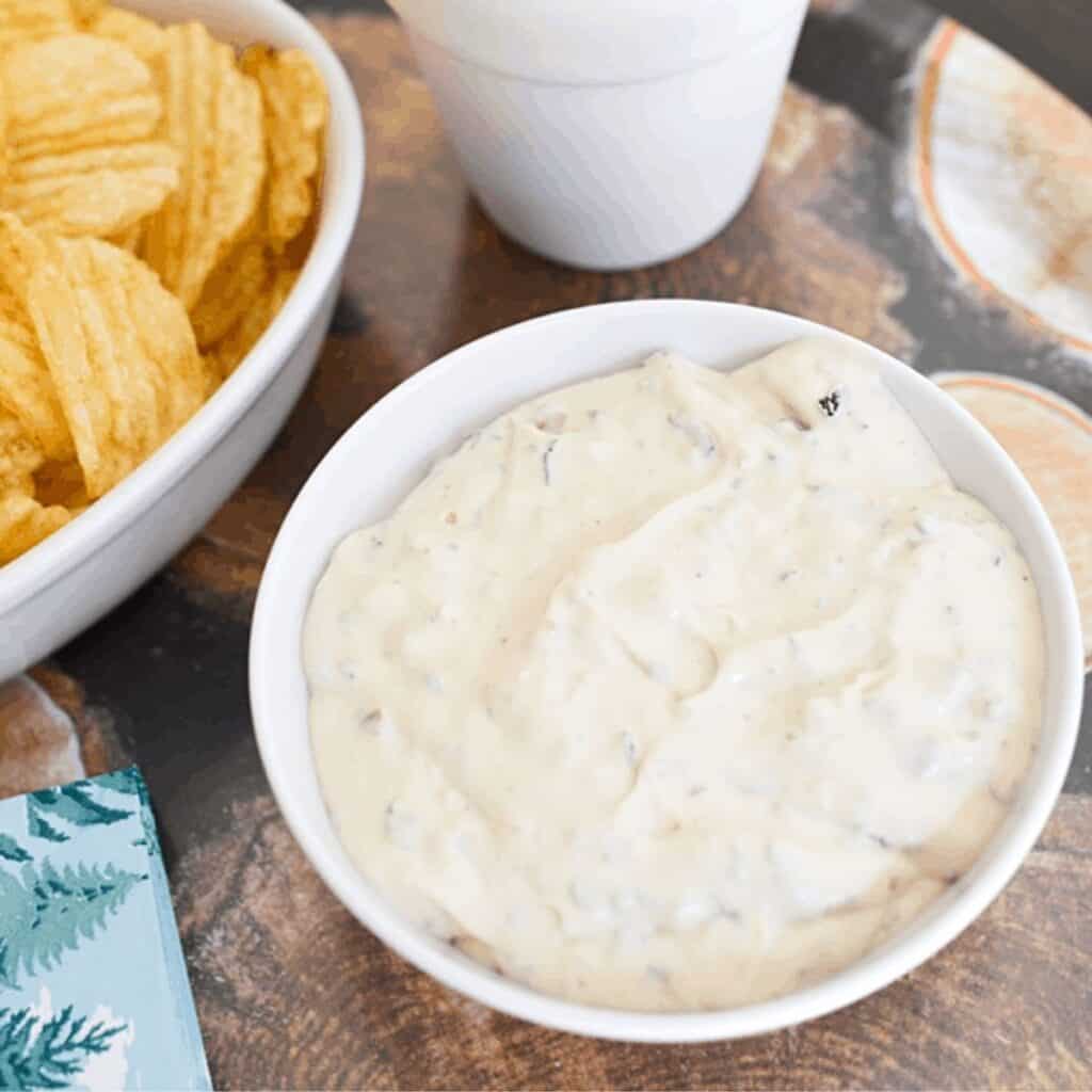 Close up of a white bowl with cold bacon dip.