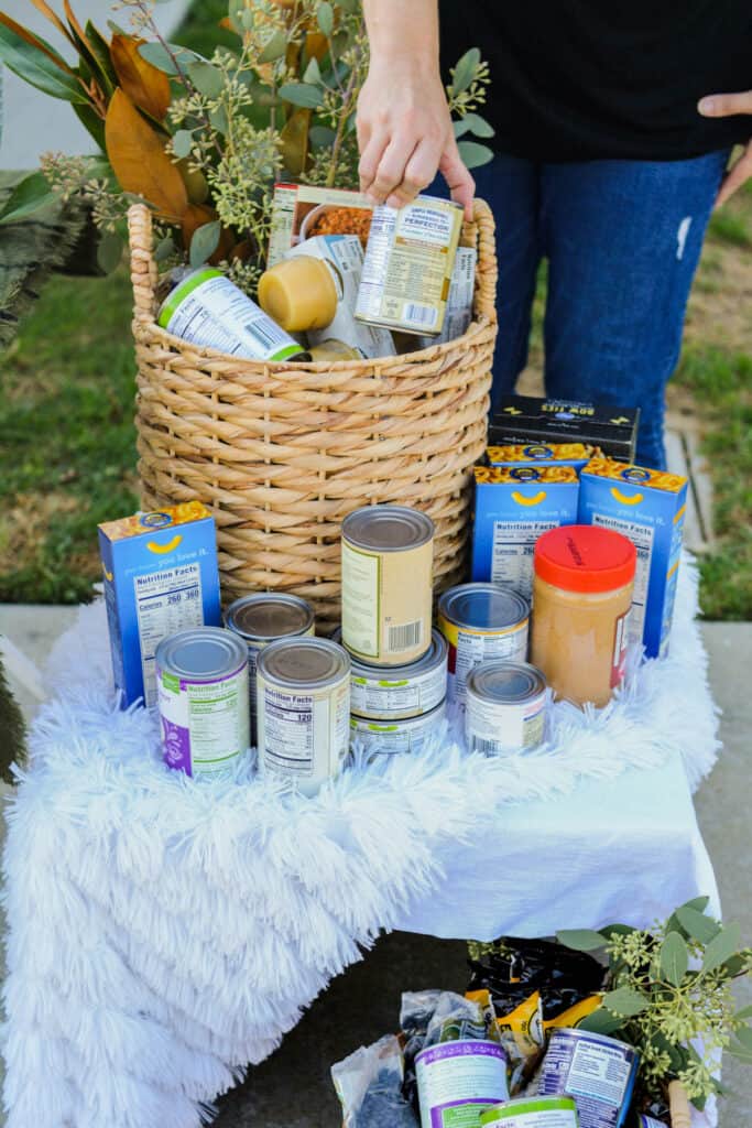 A table with baskets of donated canned food to take to the food bank.