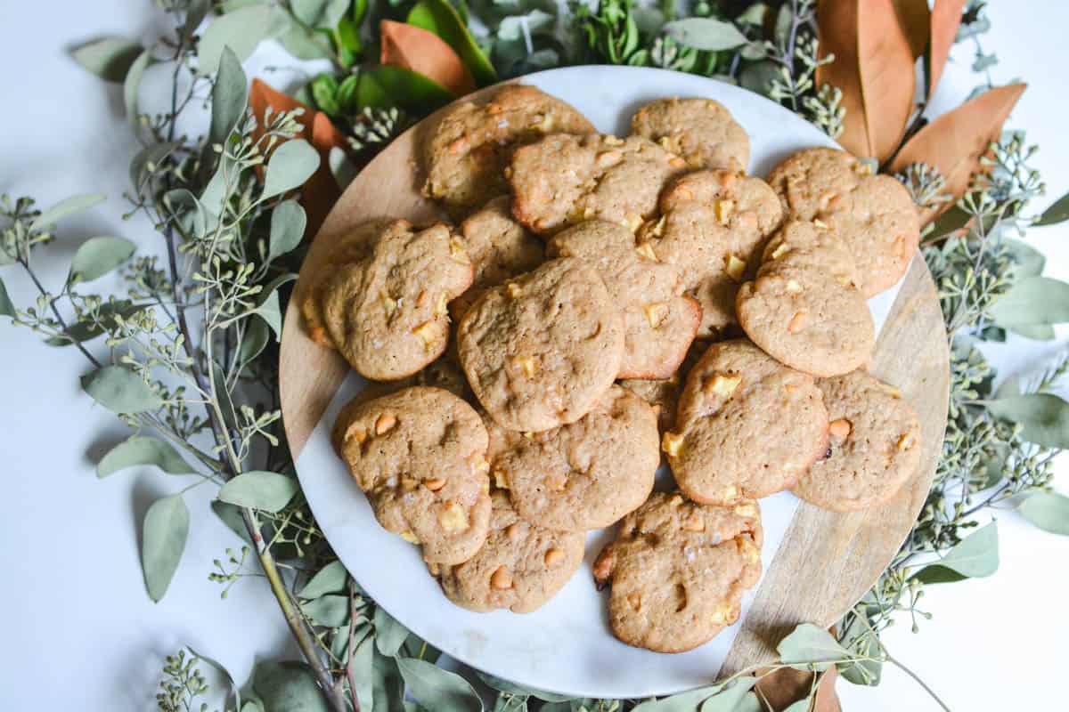 Overhead plate with cookies sitting on top of fall leaves.