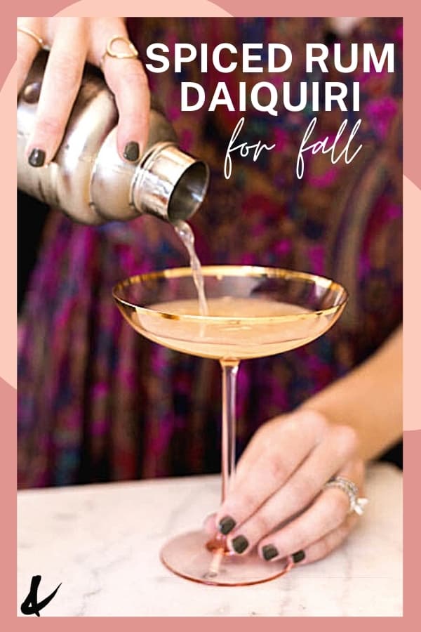 woman pouring a drink from a cocktail shaker into a coupe style glass.