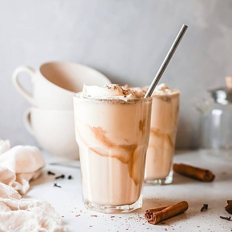 A glass holding a pumpkin pie milkshake with salted caramel.