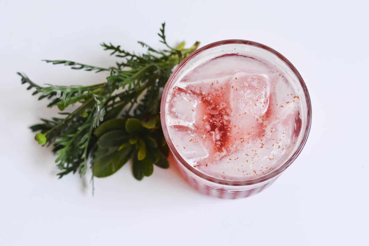 Overhead view of a Cranberry Bourbon cocktail in a glass.