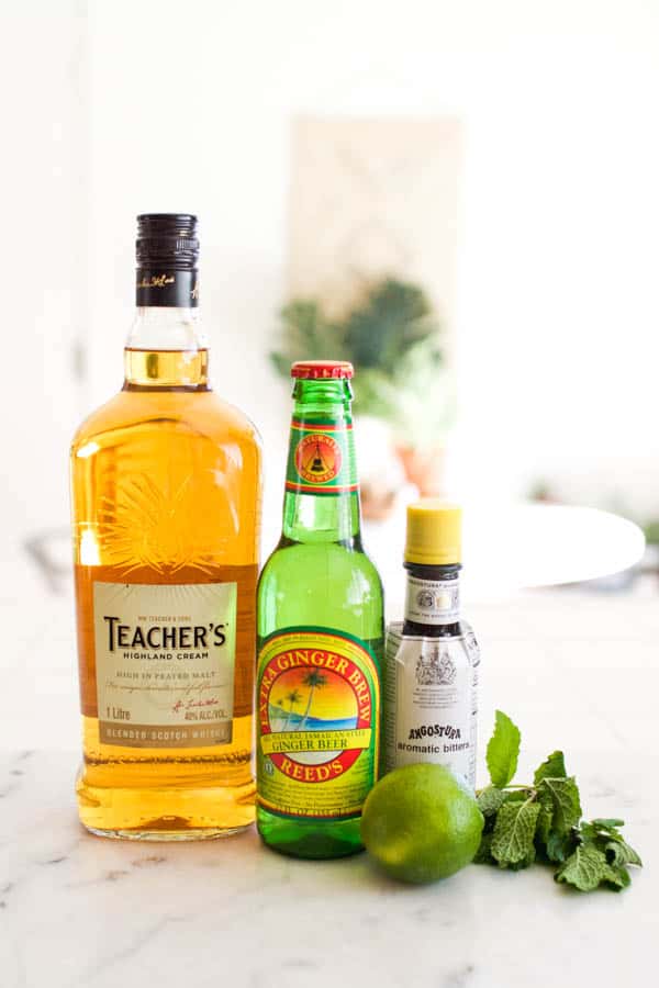 Ingredients for a scotch mule on a white marble countertop.