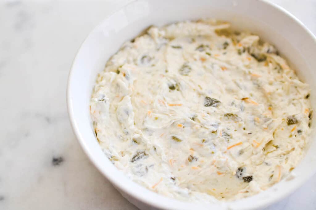 A cream cheese dip in a baking dish before baking.