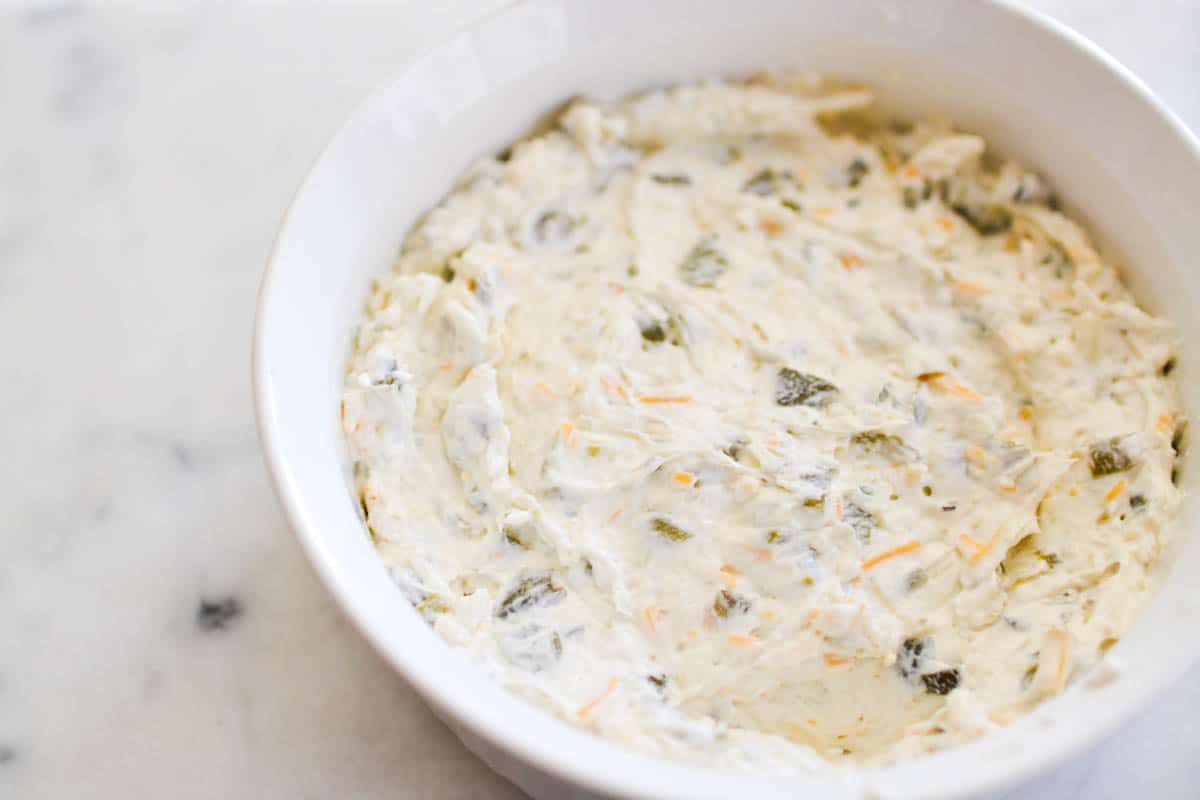 A cream cheese dip in a baking dish before baking.