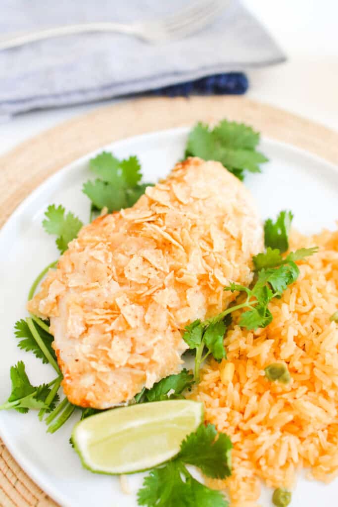 Close up of chipotle lime chicken coated in crushed tortilla chips.