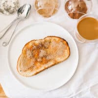 Close up of a plate with a piece of cinnamon toast.