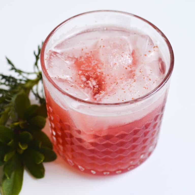 Close up for a bourbon cocktail on a table.