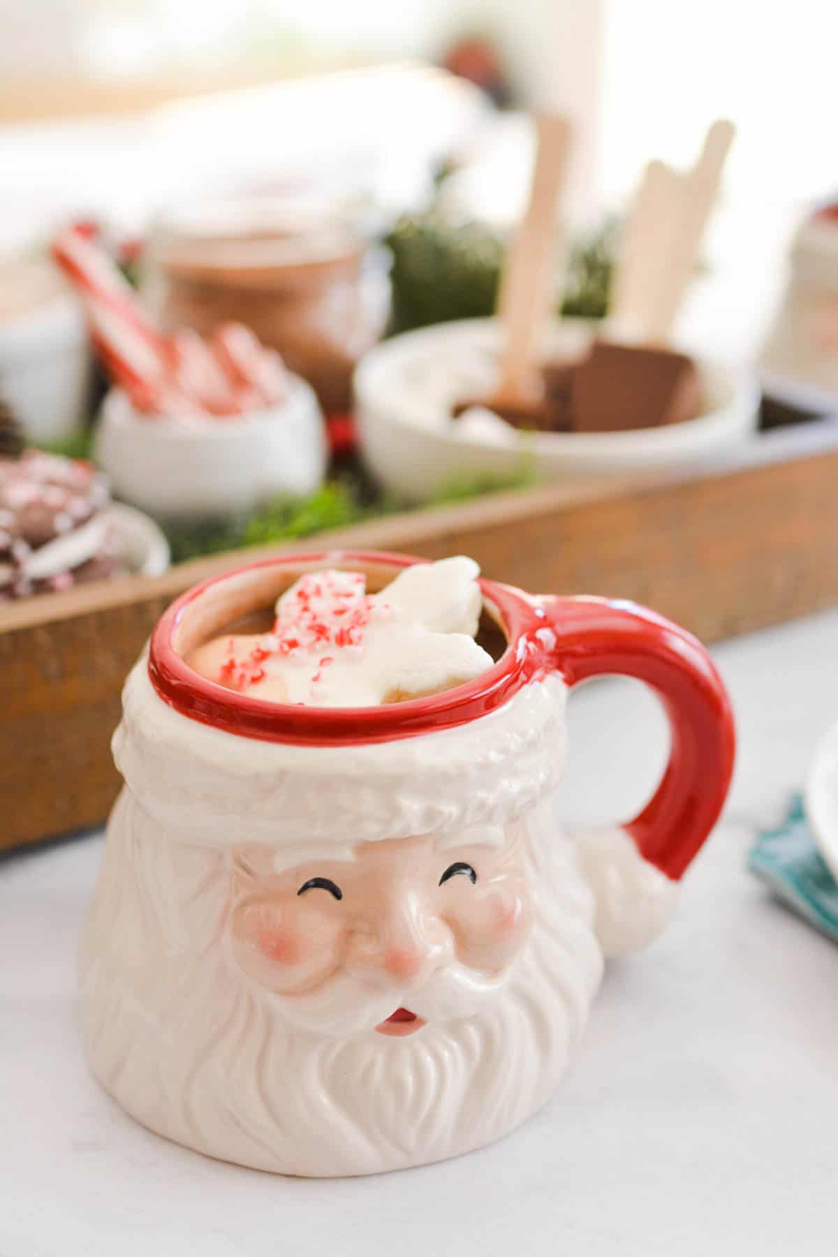 Close up of a Santa mug holding hot cocoa.