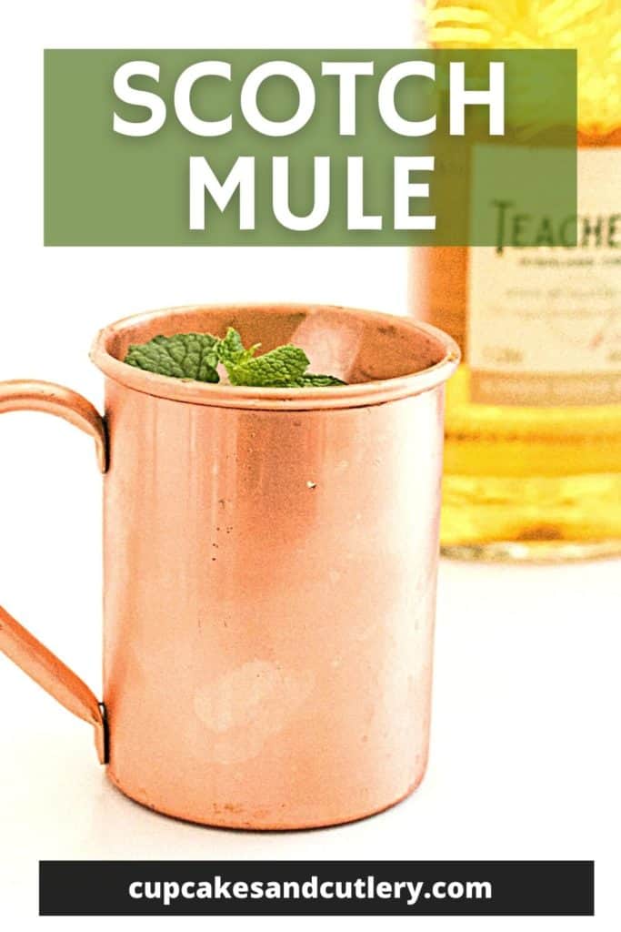 Copper mug garnished with mint filled with a Scotch Mule cocktail with a bottle of Scotch in the background.