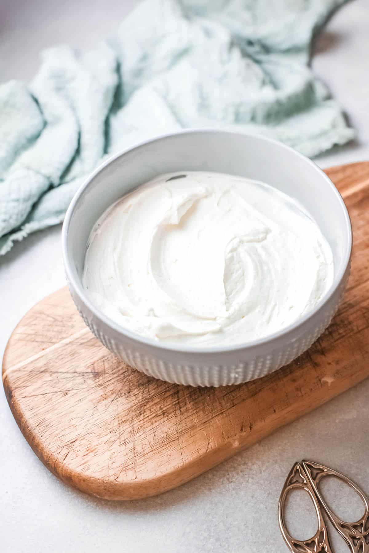 Bowl of frosting on a table.