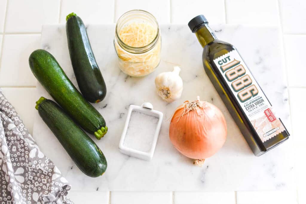 Ingredients for Sauteed Zucchini topped with parmesan.