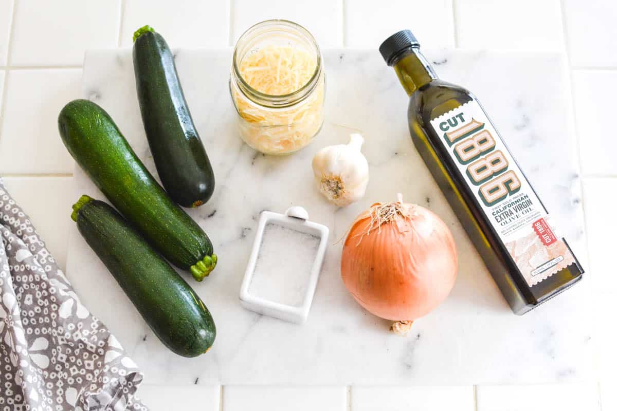 Ingredients for Sauteed Zucchini topped with parmesan.