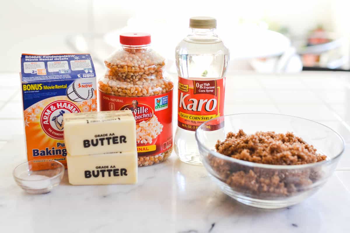 Ingredients to make homemade caramel popcorn on a counter.