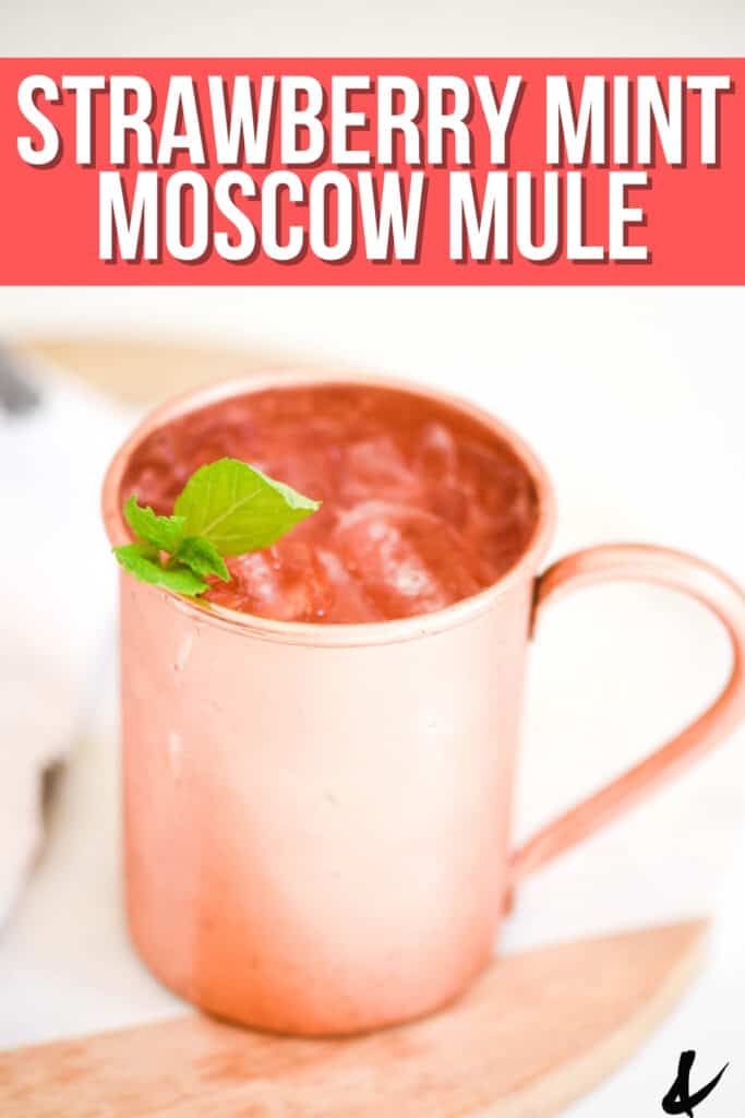 Close up of a Strawberry Mule in a copper mug with a text overlay.