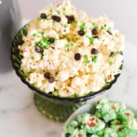 Close up of holiday popcorn coated in white chocoalte