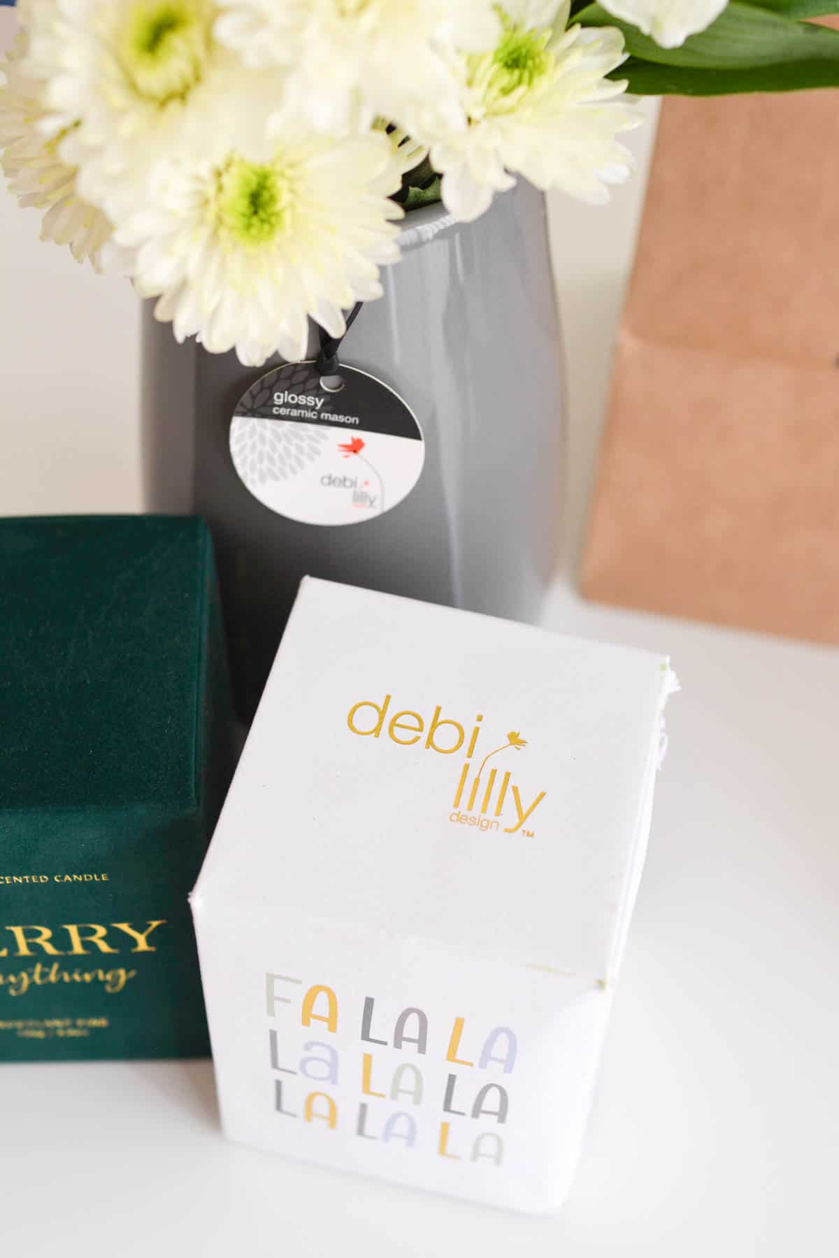Logo of Debi Lilly designs on top of a boxed candle.