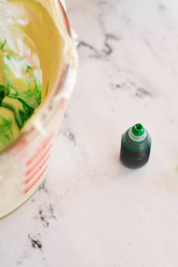 green food coloring open on a counter.