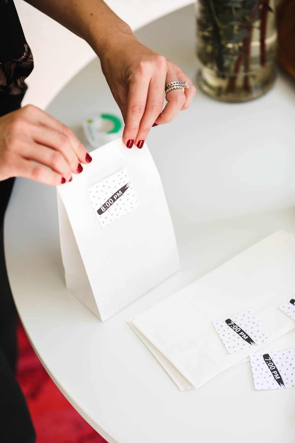 Woman folding over the top of a paper bag with a time on it.