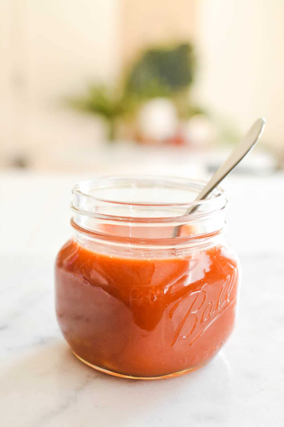Side view of a jar of tomato juice.