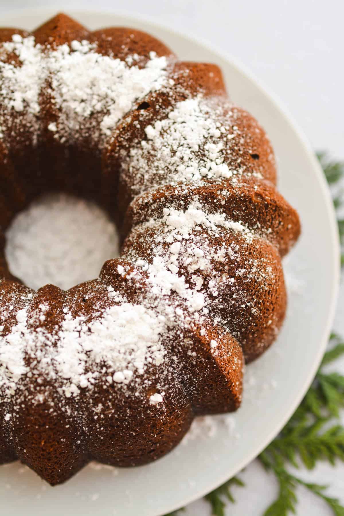 Close up of the top of a Bundt cake topped with powdered sugar.