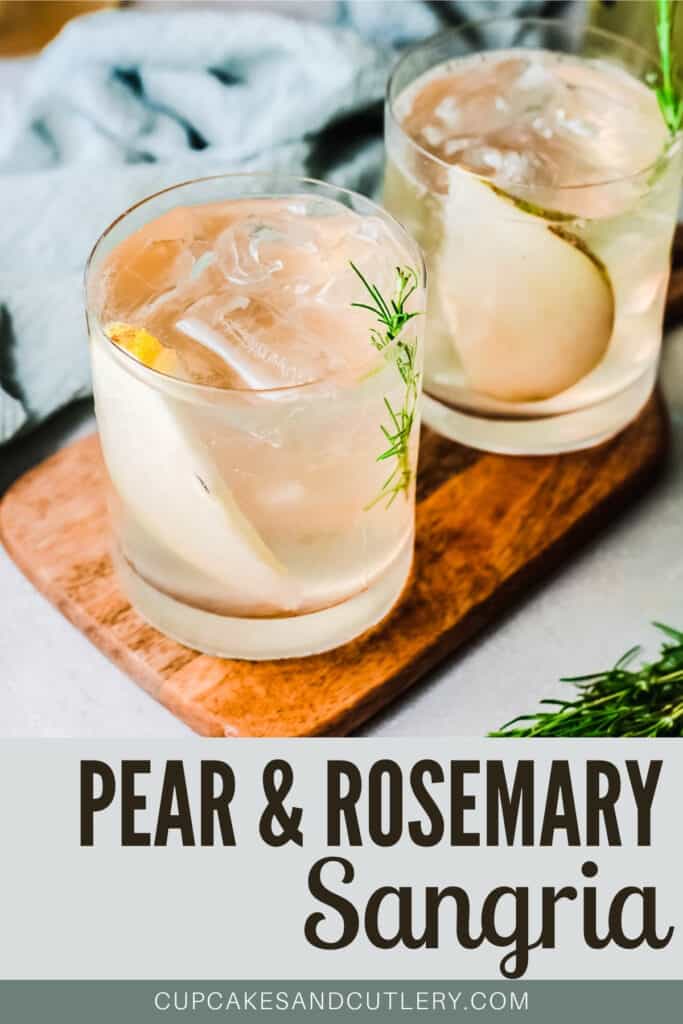 2 cocktails on a wood tray with pear slices and rosemary.