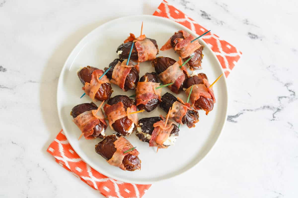 Overhead view of a platter holding bacon wrapped dates