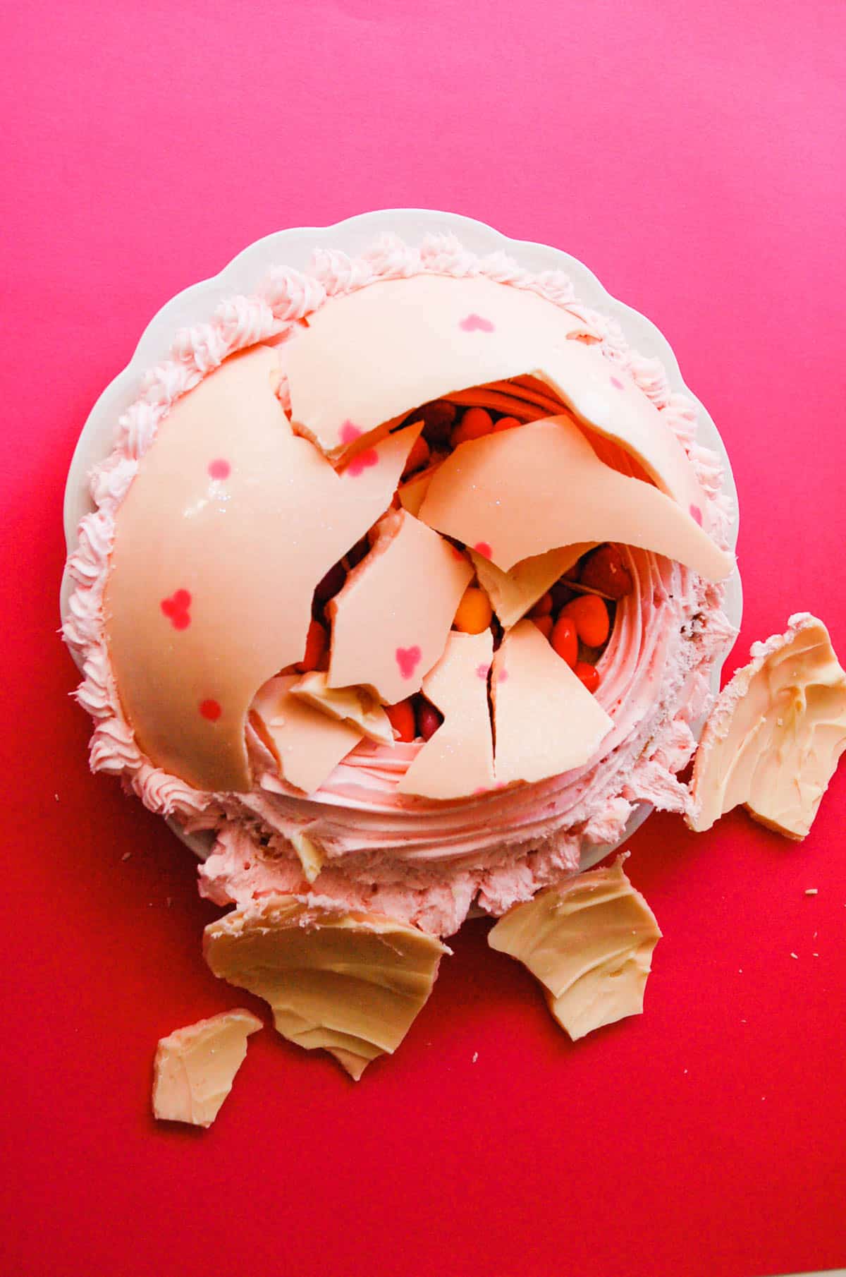 candy filled cake topped with a white chocolate dome for Valentine's Day