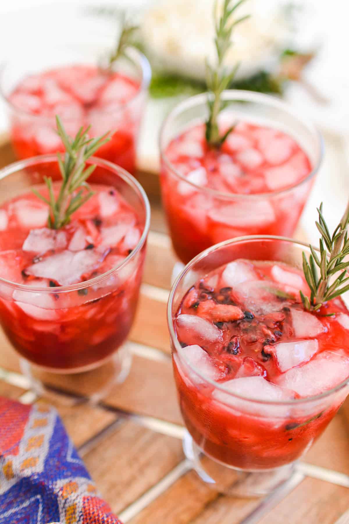 Refreshing pink cocktails with rosemary garnish.