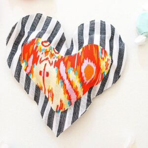 A close up of a DIY Valentine Fabric Heart Pillow.
